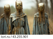 Three figures standing in open space. They wear long cloaks with hoods and masks made of rough cardboard-like materials with cutouts for the eyes. The masks are also decorated with thin branches or twigs, giving the figures an even more sinister and faceless appearance. The figures stand motionless, creating a feeling of mysticism and anxiety. The background is blurry, adding to the feeling of isolation and mystery. Стоковое AI-изображение, AI-художник Анна Кривицкая / Фотобанк Лори