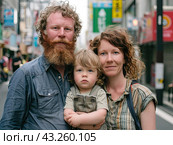 Portrait of a happy European family traveling to Japan with a small child. Стоковое AI-изображение, AI-художник Ярославский Максим / Фотобанк Лори