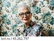 Portrait of a stylish, fashionable elderly woman, a pensioner of 70 years old, wearing glasses and clothes with floral prints. The concept of the elderly. Стоковое AI-изображение, AI-художник Photojuli / Фотобанк Лори
