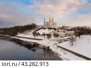 Assumption Mountain, the Holy Spirit Monastery and the Holy Assumption Cathedral on the banks of the Western Dvina and Vitba rivers on a sunny winter evening, Vitebsk, Belarus. Стоковое фото, фотограф Ula Ulachka / Фотобанк Лори