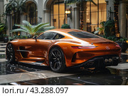 Luxury orange sports car standing on a shiny wet surface in an elegant courtyard with arches and green plants. The car has a sleek and aerodynamic design with powerful taillights and large black wheels. The background includes elements of architecture and nature, creating an atmosphere of exclusivity and style. Стоковое AI-изображение, AI-художник Анна Кривицкая / Фотобанк Лори