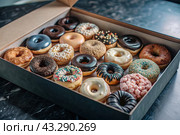 Delicious dessert. A sick box of different donuts with colorful sprinkles on the table. Confectionery products. Стоковое AI-изображение, AI-художник Photojuli / Фотобанк Лори