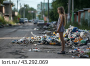 Girl standing on littered street. Стоковое AI-изображение, AI-художник Данил Руденко / Фотобанк Лори