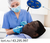 Man receiving procedure of face mesotherapy at aesthetic cosmetology clinic. Стоковое фото, фотограф Яков Филимонов / Фотобанк Лори