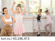 Woman teacher corrects movement of girl dancer. Стоковое фото, фотограф Яков Филимонов / Фотобанк Лори