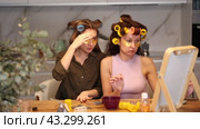 Two women curl their hair with curlers and use patches. Стоковое видео, видеограф Яков Филимонов / Фотобанк Лори