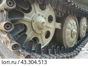 Detail of tank (armoured fighting vehicle), primary offensive weapon in front-line ground combat. Good battlefield mobility provided by tracks. Mainstay of modern 20th and 21st century ground forces. Стоковое фото, фотограф YuryKara / Фотобанк Лори