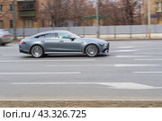 Side view of gray Mercedes-AMG GT 4-Door Coupe. Fast moving car on the street. Vehicle driving along the street in city with blurred background. (2021 год). Редакционное фото, фотограф Константин Григорьев / Фотобанк Лори