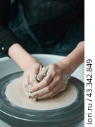 Woman making ceramic pottery on wheel, hands close-up, creation of ceramic ware. Стоковое фото, фотограф Natalia Gdovskaia / Фотобанк Лори