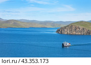 LAKE BAIKAL, SAKHYURTA VILLAGE, IRKUTSK REGION, RUSSIA -  July 04, 2009:  Top view of Olkhonskie Vorota regular cargo and passenger ferry with tourists from the famous Olkhon Island. Редакционное фото, фотограф Виктория Катьянова / Фотобанк Лори