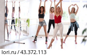 Expressive female dance instructor leading with confidence group rehearsal, performing sensual choreography in high heels, epitomizing modern grace and femininity in sunlit studio. Стоковое видео, видеограф Яков Филимонов / Фотобанк Лори
