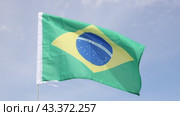 Brazil flag waving against the blue sky. Стоковое видео, видеограф Яков Филимонов / Фотобанк Лори