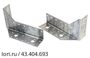 Металлический крепежный угольник на белом фоне. Metallic angle fixator on white background. Стоковое фото, фотограф Татьяна Д / Фотобанк Лори