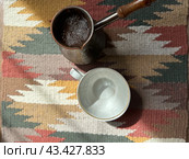 Кофе на ковре с геометрическим узором на деревянном полу. Стоковое фото, фотограф Галя Некрасова / Фотобанк Лори