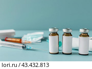 Syringe and glass vial on blue background table. Medical Vials group, needles, ampoules, bottle with medicines or vaccine. Disease treatment. Creative Banner. Anti-aging beauty injections. Vaccination. Стоковое AI-изображение, AI-художник Марина Демидюк / Фотобанк Лори