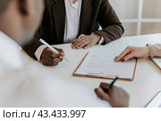 Managers conduct interviews with job applicants and a preliminary check. The candidate signs the necessary documents. Стоковое AI-изображение, AI-художник Ярославский Максим / Фотобанк Лори