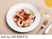 There is portion of seafood tapas salpicon with green and black olives on plate. Стоковое фото, фотограф Яков Филимонов / Фотобанк Лори