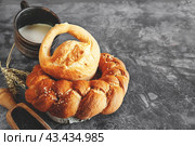 Assortment of white bread. Kalach and challah made of wheat flour on table with milk. Copy space. Стоковое фото, фотограф Оксана Медведева / Фотобанк Лори