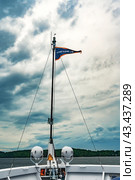 Karelia, Russia, July 21, 2023. Deck of the motor ship Symphony of the North, triangular pennant of the tour company Sozvezvedie on the flakshtok. The theme of traveling in northern regions and cold water spaces. Редакционное фото, фотограф Оксана Медведева / Фотобанк Лори
