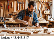 A carpenter in the workshop makes a wooden chair. The concept of craft. Стоковое AI-изображение, AI-художник Ярославский Максим / Фотобанк Лори