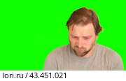 Upset man over plain green background. Adult bearded fun confused shy shamed bemused guy. Green screen chromakey. Handsome sad male looking dissatisfied sadness isolated greenscreen. Expressing sorrow. Стоковое видео, видеограф Марина Демидюк / Фотобанк Лори