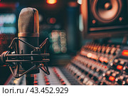 Microphone in the studio against the background of the director's console. The concept of freedom of speech. Стоковое AI-изображение, AI-художник Ярославский Максим / Фотобанк Лори