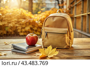 The holiday is on September 1st. A backpack, sneakers, an apple and pencils. Back to school. The concept of a new academic year at school. Autumn Knowledge Day. Стоковое AI-изображение, AI-художник Photojuli / Фотобанк Лори