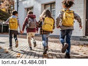 The holiday falls on September 1st. Children with yellow backpacks run to school. Rear view. Back to school. The concept of a new academic year at school. Autumn Knowledge Day. Стоковое AI-изображение, AI-художник Photojuli / Фотобанк Лори