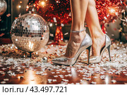 Women's legs in luxurious shiny pumps with heels at a party or disco on the background of a silver mirrored disco ball. The queen of the dance floor. Стоковое AI-изображение, AI-художник Photojuli / Фотобанк Лори