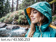 Close-up. A happy young woman in a raincoat enjoys the rain on the background of a green forest, the concept of enjoying a natural leisurely life, environment, lifestyle. Стоковое AI-изображение, AI-художник Photojuli / Фотобанк Лори