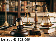 Justice and the law. A wooden hammer, books and scales on the table. The court session. Стоковое AI-изображение, AI-художник Photojuli / Фотобанк Лори