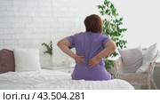 Back pain, kidney inflammation, woman suffering from backache at home, health problems concept. Стоковое видео, видеограф Станислав Тарко / Фотобанк Лори