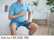 Heart attack, man with chest pain suffering at home, myocardial infarction. Стоковое фото, фотограф Станислав Тарко / Фотобанк Лори
