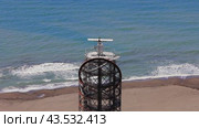 Aerial photography of marine navigation radar installed on seashore. Closeup of radar showcasing its structure and functionality. Radar plays crucial role in maritime navigation. Стоковое видео, видеограф ILIA GOROKHOV / Фотобанк Лори
