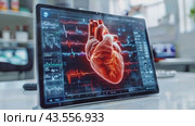 Tablet displaying a vibrant red holographic heart with pulse lines on table in doctor's office. Стоковое AI-видео, аниматор Елена Никишина / Фотобанк Лори