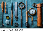 Assorted Tools and Equipment on a Blue Gridded Surface. Стоковое AI-изображение, AI-художник Сергей Толмачёв / Фотобанк Лори