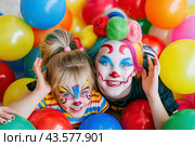 Mother and daughter decorated like clowns. A birthday party for children. A bright clown and a holiday. Стоковое AI-изображение, AI-художник Ярославский Максим / Фотобанк Лори