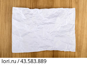 Top view of a crumpled piece of white office paper on a white background. Стоковое фото, фотограф Сергей Долгов / Фотобанк Лори
