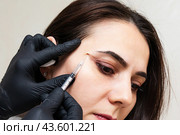 Plastic surgery. Beautician doctor with botulinum toxin syringe making injection to to remove crow's feet. Cheek volume enhance mesotherapy. Anti-aging treatment and face lift in cosmetology clinic. Стоковое фото, фотограф Ирина Михайличенко / Фотобанк Лори