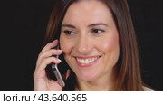A joyful woman is smiling, talking on her phone, and expressing happiness through gestures. Стоковое AI-видео, аниматор Юрий Поздников / Фотобанк Лори