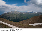 View of the Great Caucasian Ridge opening from the Upper station of the cable car system of the Dombay ski resort on a summer day, Karachay-Cherkessia, Russia. Стоковое фото, фотограф Ula Ulachka / Фотобанк Лори