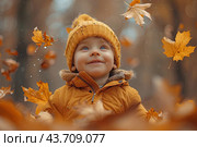 Little boy having fun during stroll in the forest at sunny autumn day. Child playing maple leaves. Baby tossing the leaves up. Active family time on nature. Hiking with little kids. Dry leaves rustle. Стоковое AI-изображение, AI-художник Ирина Михайличенко / Фотобанк Лори