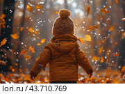 Little boy having fun during stroll in the forest at sunny autumn day. Child playing maple leaves. Baby tossing the leaves up. Active family time on nature. Hiking with little kids. Dry leaves rustle. Стоковое AI-изображение, AI-художник Ирина Михайличенко / Фотобанк Лори