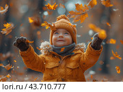 Little boy having fun during stroll in the forest at sunny autumn day. Child playing maple leaves. Baby tossing the leaves up. Active family time on nature. Hiking with little kids. Dry leaves rustle. Стоковое AI-изображение, AI-художник Ирина Михайличенко / Фотобанк Лори
