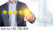 Person man pointing on 5 star review, costumer feedback concept - five stars rating. Feedback, reputation and quality concept. blurred office background. Стоковое фото, фотограф Павел Муравьев / Фотобанк Лори