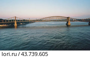 There exists a magnificent bridge that elegantly spans over a serene body of water nearby. Стоковое AI-видео, аниматор Юрий Поздников / Фотобанк Лори