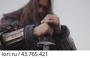 Warrior praying holding a sword. Стоковое видео, видеограф Илья Шаматура / Фотобанк Лори