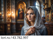 Portrait of a beautiful young woman in a headscarf in an Orthodox church. A girl prays in a church against the background of icons. Стоковое AI-изображение, AI-художник Photojuli / Фотобанк Лори