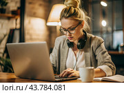A young female freelance businessman in glasses and headphones is working on a laptop or shopping in an online store. The woman is writing something in a notebook. Стоковое AI-изображение, AI-художник Photojuli / Фотобанк Лори