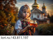The concept of the Russian Orthodox holiday Honey Savior. A beautiful little girl in Russian national clothes and a scarf with a jar of honey on the background of an Orthodox church. Стоковое AI-изображение, AI-художник Photojuli / Фотобанк Лори